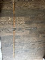Full length fold-out view of wooden tape measure on wooden floor