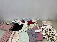 Overview image showing 17 toddler clothing pieces from Zara and H&M, mostly pants and tops in pastel and neutral colors