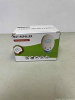 Image of the front of one box showing the pest repeller packaging with LED night light and eco technology features.