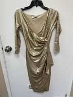 Full view of a metallic gold Chiara Boni La Petite Robe dress size 4 with long sleeves and draped front detail.