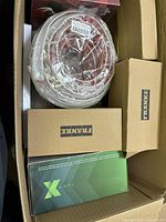 View of the box contents showing coiled hose, multiple FRANKE boxes, and Xploria box.