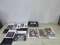 View of all packaged items laid out on floor including evergreen window shadowscapes and diamond painting kits