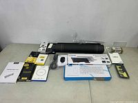 Overview of all items including keyboards, mouse, cables, protective cases and box packaging displayed on a table.