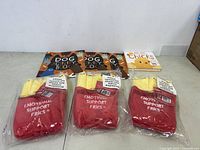 All items in lot displayed: 3 Dog Activity Books, 3 Emotional Support Fries plush toys, 1 Here Come the Chicks board book.