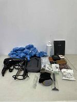 Overview of all items including hair dryer, gloves, wallets, lotion bottle, diary, and accessories.