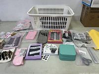 Overview of all items including laundry basket, eyelashes, hair clips, phone cases, makeup sponges, and storage containers.