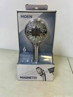Front view of the Moen Magnetix 6 setting shower head in packaging displaying the product prominently through clear plastic.