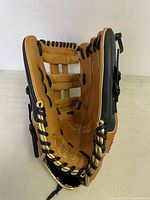 Baseball glove displayed open showing inside pocket, branding, and black laces.