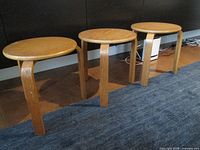 Three bentwood stacking stools side by side