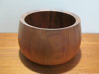 Front view of round teak wooden bowl
