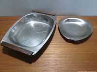 Serving tray with three smaller triangular stainless steel dishes stacked alongside, showing overall lot contents and size.