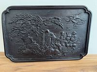 Front view of rectangular carved zitan plaque depicting an immortal with two children carrying peaches, deer under tree, cranes flying