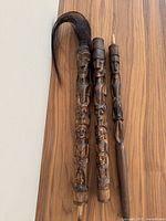 Photo showing the staff disassembled into three wooden carved pieces topped with horsehair.