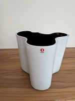 Front view of white exterior with black interior, showing form and Iittala logo.