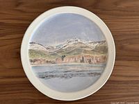 Front view of the ceramic decorative plate showing the painted Mt. Garibaldi and Squamish River scene.