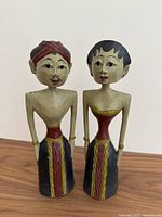 Front view of the pair of Loro Blonyo wooden figures, showing detailed facial features, traditional attire, and hand painted finish.