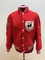 Front view of red varsity jacket featuring chenille UBC Engineers badge and snap button closure.