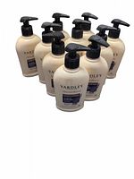 Photo showing 10 white plastic bottles with pump dispensers labeled Yardley English Lavender body lotion.