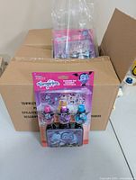 Vampirina kid-safe nail polish cosmetic set with decorative tin in original sealed packaging over cardboard box background.