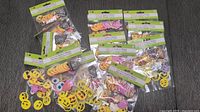 15 packs of assorted foam emoticon stickers spread out showing various emoticons and characters.