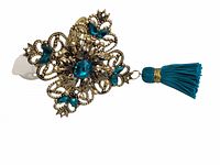 Single turquoise and gold napkin ring with tassel, showing intricate filigree, blue stones, and tassel detail