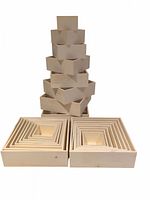 Two stacks of nested natural wood square boxes arranged in pyramid shape showing all boxes in both sets.