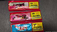 Three foam flying glider toys in packaging, displaying the Focke Wulf 190 A-4, Mitsubishi Zero, and Airacobra P-39 styles.