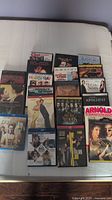 Lot of DVDs and Blu-Rays displayed in two rows showing titles and cover art.