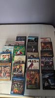 Photo showing 20 assorted DVDs and Blu-rays including Outlander Season 1 and other movies.