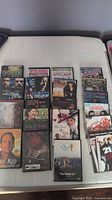 Photo showing 20 assorted used DVDs with visible titles in action, drama, series, and kids categories.
