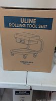 Image of the packaging box showing ULINE branding and illustration of the rolling tool seat.