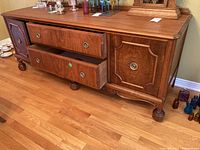 Front view showing two center drawers and left/right doors with brass ring pull hardware