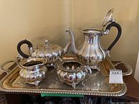 Full view of the five piece Rogers 1881 silverplate tea set on the serving tray, showing teapot, coffee pot, cream pitcher, sugar bowl, and decorated tray.