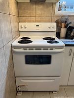 Full front view of white Frigidaire stove showing burners, oven door, control panel