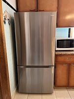 Exterior front view of closed stainless steel refrigerator