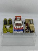 Front view of three Hot Wheels Red Line replica cars displayed side by side showing top surfaces and paint details