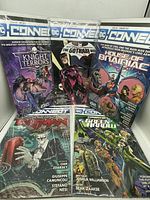 Front view of five DC Connect comics in individual clear protective sleeves.