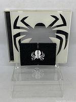 Closed view of hand painted custom PS2 memory cards and matching case with Spiderman black spider logo