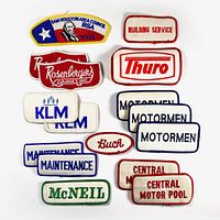 Overview of 16 patches including corporate names and council patches laid flat on white background.