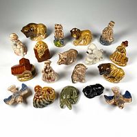 Overview of all 18 porcelain figurines arranged in rows on a white surface with good lighting showing colors and shapes distinctly