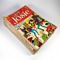 Stack of Josie comic books from the Silver Age showing illustrated cover with characters dancing and playing music.