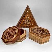 Photo showing all three vintage marquetry boxes: triangular, hexagonal, and octagonal shapes with inlaid shell and wood geometric patterns, largest box open to reveal red interior.