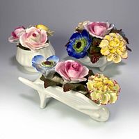 Three vintage Stratford porcelain flower bouquet figurines arranged together on a flat surface, showing the detailed colorful flowers and white containers.