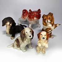 Group shot of all five ceramic dog figurines in different colors and poses, showing size and detail.