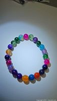 Front view of colorful rainbow agate bead bracelet showing variety of colors and bead polish.