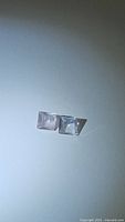 Two square cut pale pink rose quartz gemstones on white background from overhead light showing clarity and cut.
