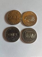 Top view of 1972 Canadian dollar coin with canoe and 1973 coin with loon design