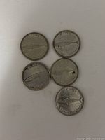 Five Canadian 10-cent coins from 1967 showing reverse with fish design