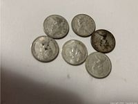 Six Centennial Roosevelt dimes, obverse (front) side showing Roosevelt's portrait on each coin with varying tones and wear.