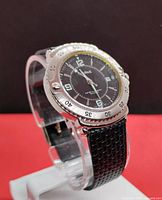 Front angle view of Cardinal men's dive style wristwatch on display stand showing black dial, silver bezel, and textured black leather strap.
